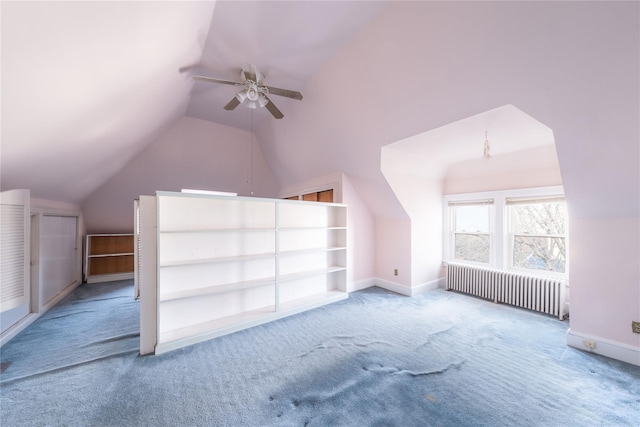 bonus room with carpet flooring, radiator heating unit, vaulted ceiling, and ceiling fan