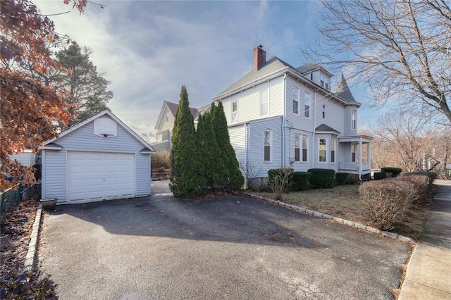 view of property exterior featuring an outbuilding and a garage