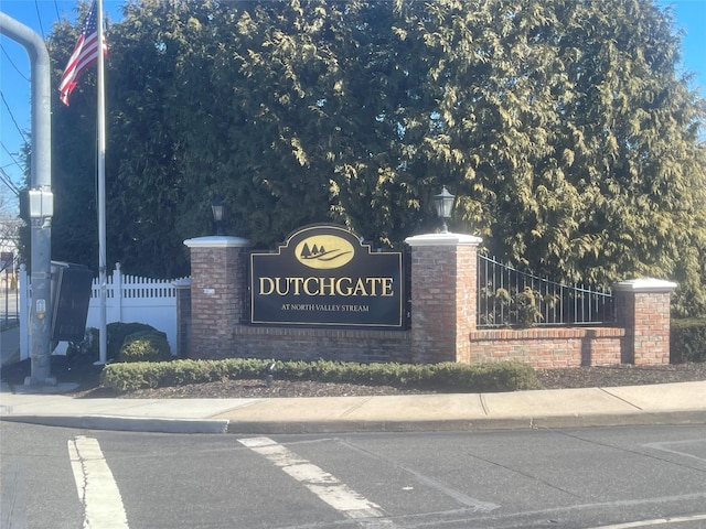 community / neighborhood sign with fence