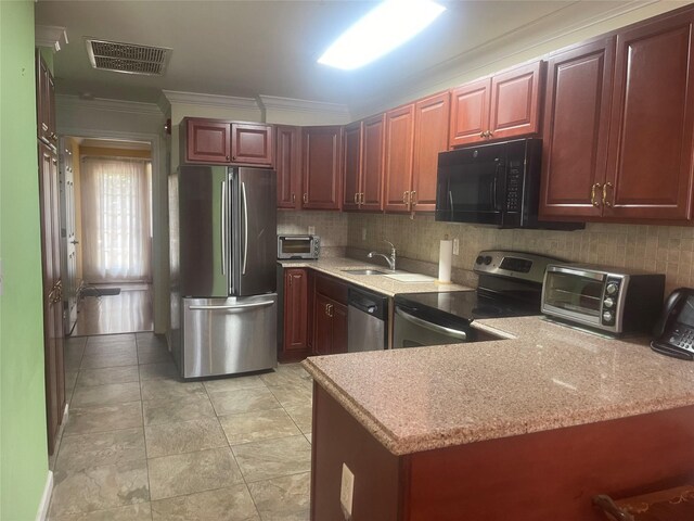 kitchen featuring visible vents, decorative backsplash, appliances with stainless steel finishes, crown molding, and a sink