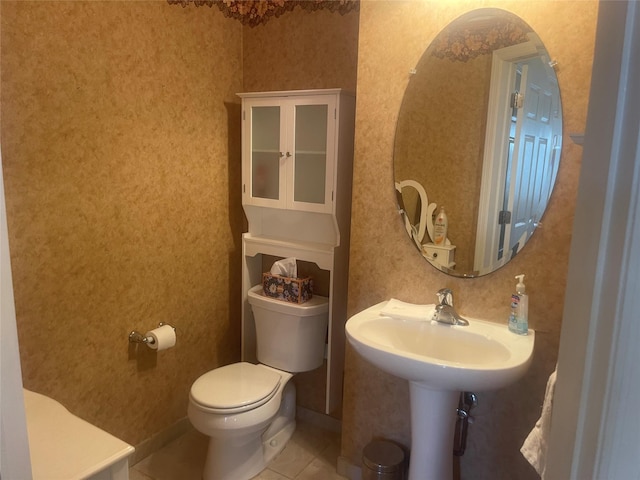 bathroom featuring toilet, wallpapered walls, and tile patterned floors