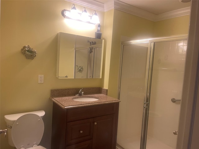 full bathroom featuring ornamental molding, a stall shower, vanity, and toilet