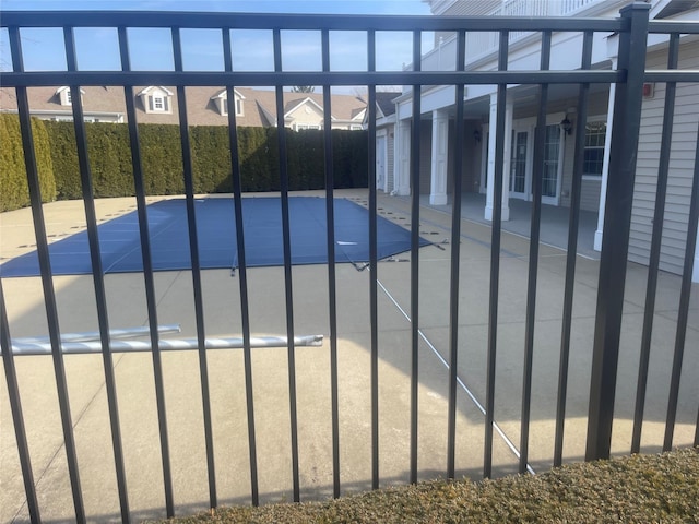 view of swimming pool with a residential view and french doors