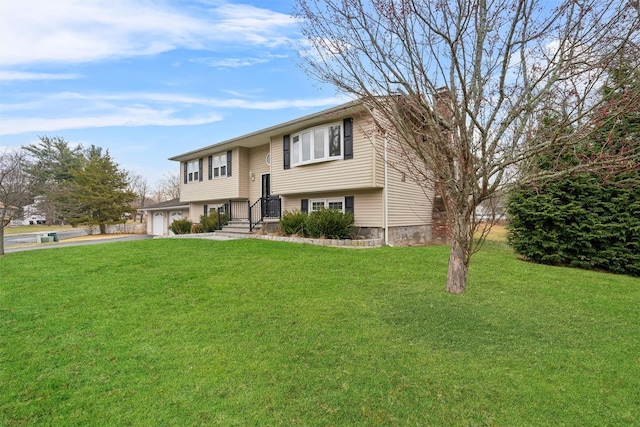 split foyer home featuring a garage and a front yard