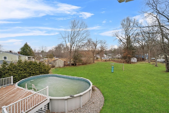 view of pool featuring a wooden deck and a yard