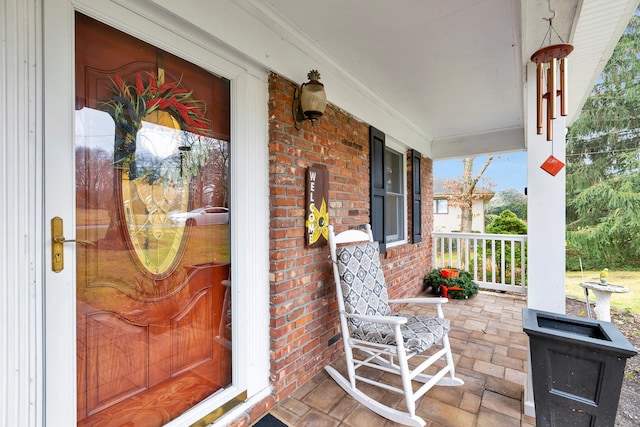 view of exterior entry featuring a porch