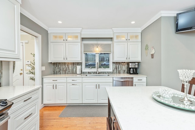 kitchen with white cabinetry, sink, and tasteful backsplash