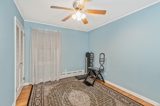 exercise area featuring ornamental molding, ceiling fan, and light hardwood / wood-style flooring