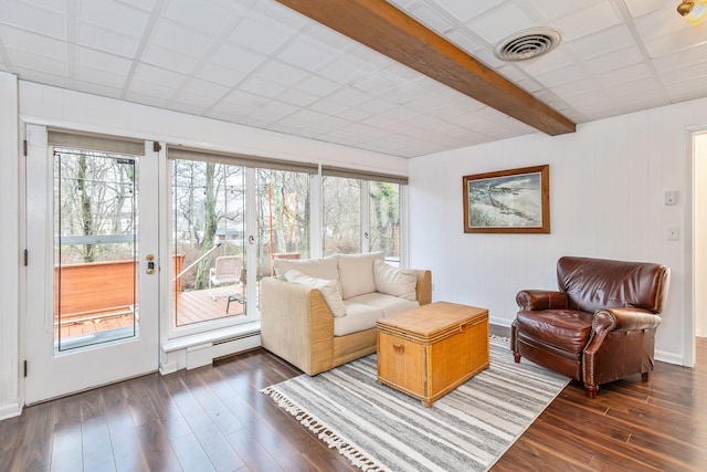 living room with a baseboard heating unit and dark wood-type flooring