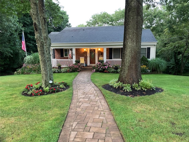 view of front of property with a porch and a front yard