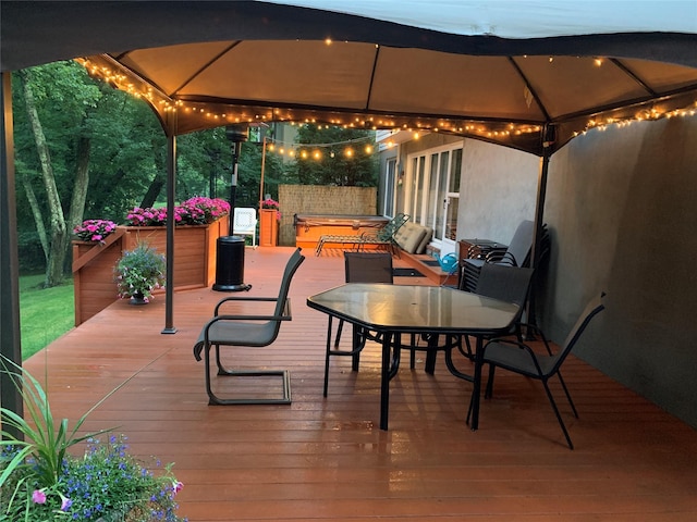 wooden deck featuring a hot tub and a gazebo