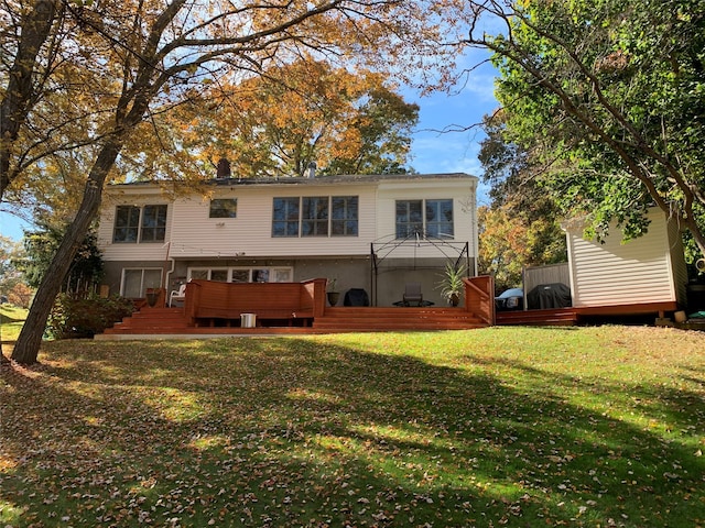 back of property with a wooden deck and a yard