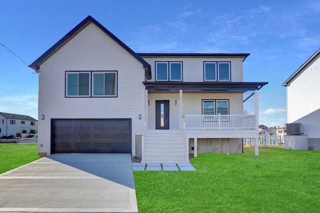 view of front of home featuring covered porch, a garage, and a front yard