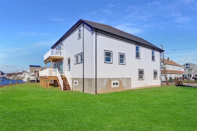 rear view of property with a wooden deck and a yard