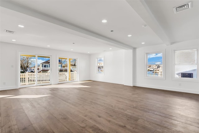 unfurnished living room featuring beamed ceiling and wood-type flooring