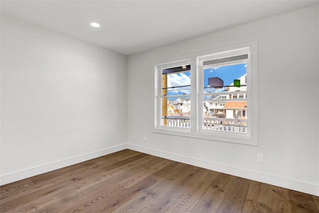 unfurnished room featuring hardwood / wood-style flooring