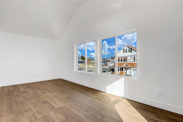 interior space featuring light wood-type flooring and vaulted ceiling