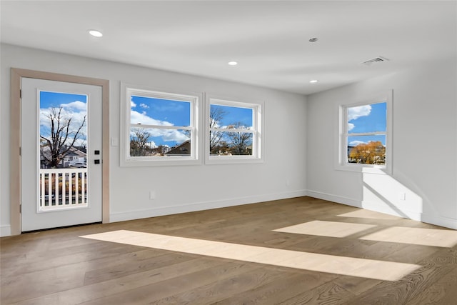 empty room with light hardwood / wood-style floors