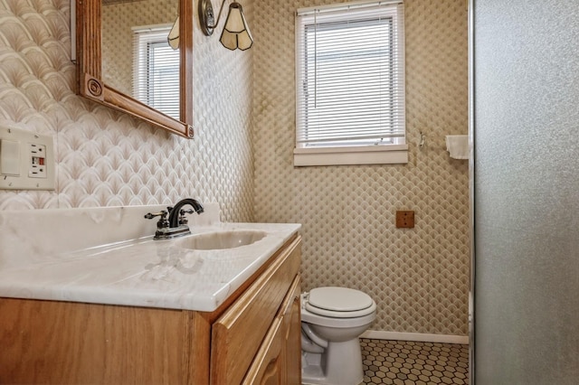 bathroom with tile patterned flooring, vanity, and toilet