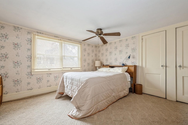 bedroom featuring ceiling fan and light carpet