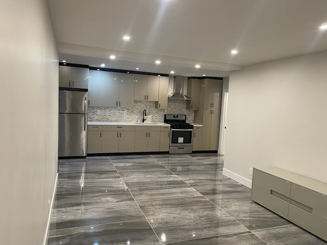 kitchen with gray cabinetry, sink, wall chimney exhaust hood, appliances with stainless steel finishes, and tasteful backsplash