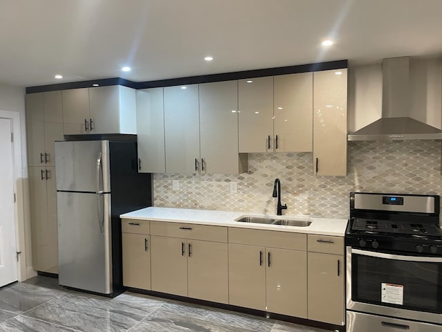 kitchen featuring decorative backsplash, sink, stainless steel appliances, and wall chimney range hood