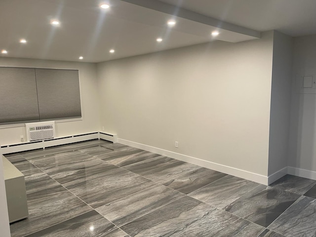 empty room featuring a wall mounted AC and a baseboard heating unit