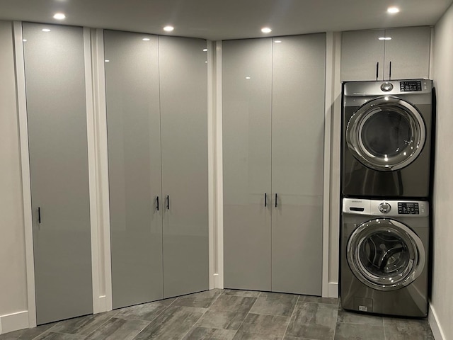 washroom featuring stacked washer and clothes dryer