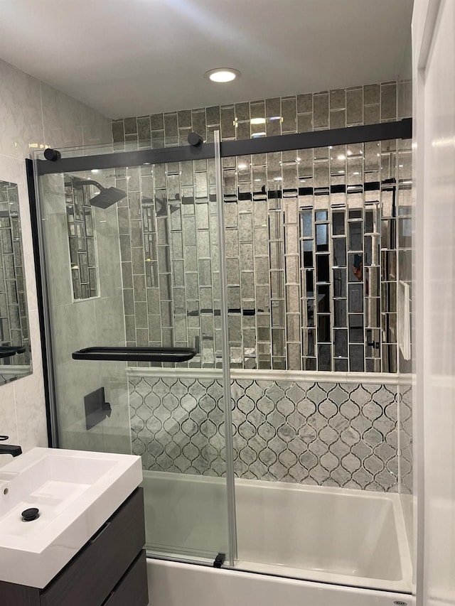 bathroom with shower / bath combination with glass door and vanity