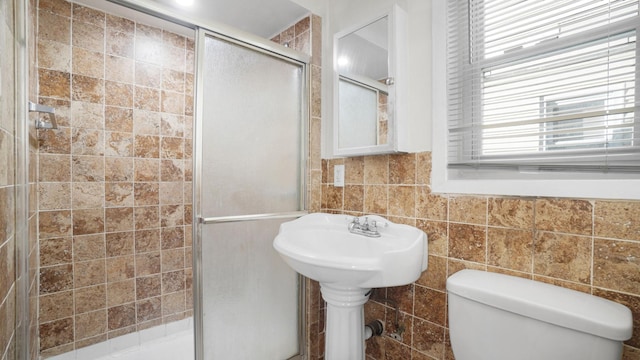 bathroom with walk in shower, tile walls, and toilet