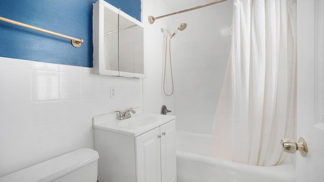 full bathroom featuring vanity, toilet, tile walls, and shower / tub combo with curtain