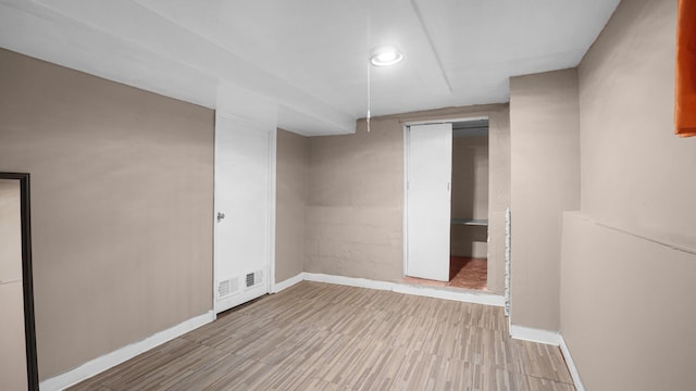 basement featuring light wood-type flooring