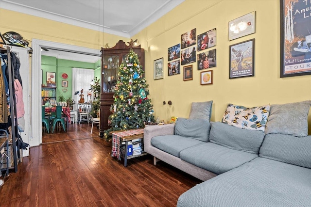 living room with hardwood / wood-style flooring and ornamental molding