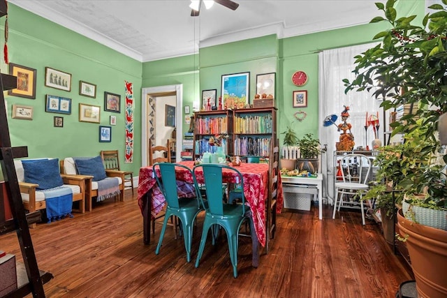 dining area with ornamental molding, ceiling fan, and dark wood-type flooring