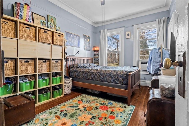 bedroom featuring ceiling fan, cooling unit, dark hardwood / wood-style floors, and ornamental molding