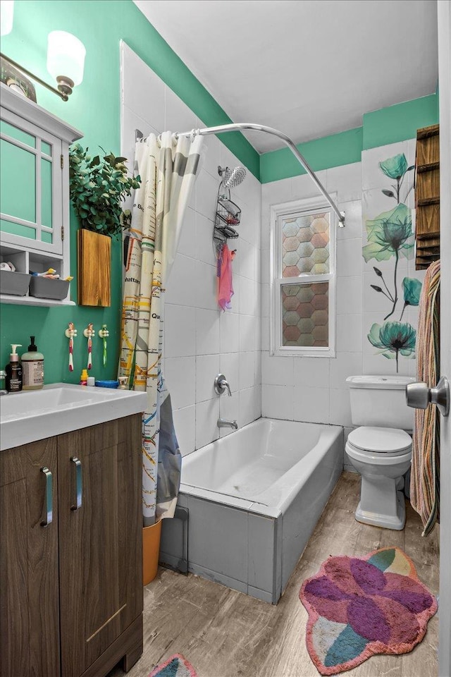 full bathroom with shower / bath combo, hardwood / wood-style floors, toilet, vanity, and tile walls