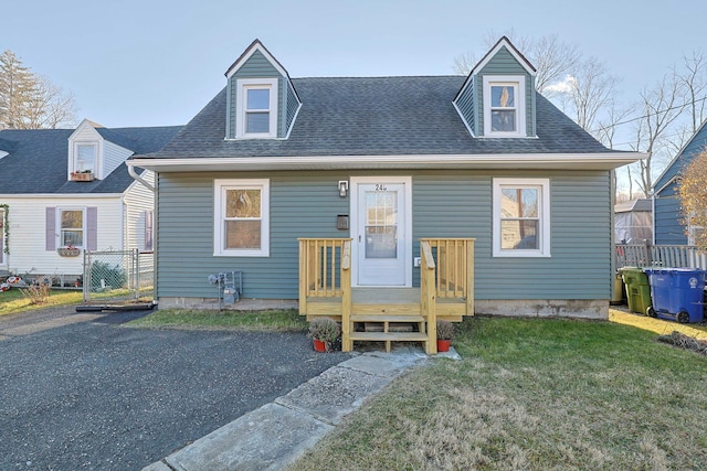 cape cod-style house with a front yard