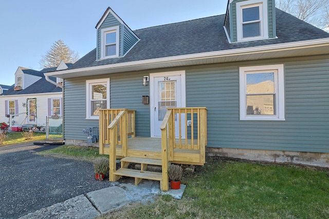 cape cod house with a deck