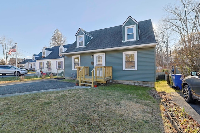 cape cod home with a front yard