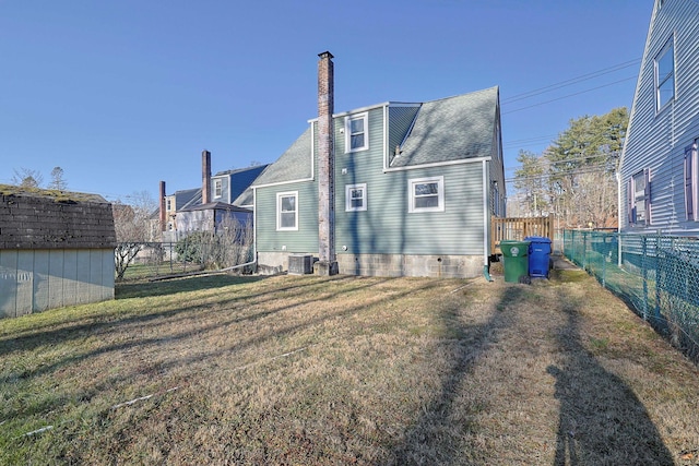 back of property featuring a yard, a shed, and cooling unit