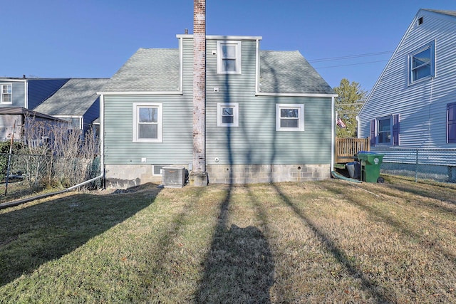 rear view of house featuring a yard and central AC unit