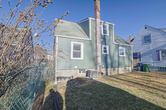 back of house with a yard and cooling unit