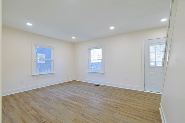 spare room with light hardwood / wood-style floors and a wealth of natural light