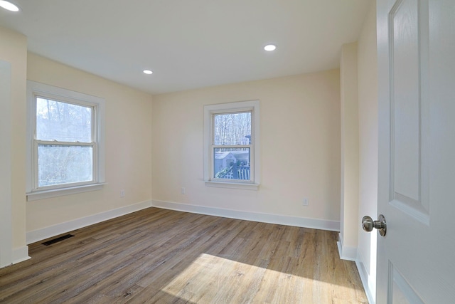 empty room featuring hardwood / wood-style flooring and plenty of natural light