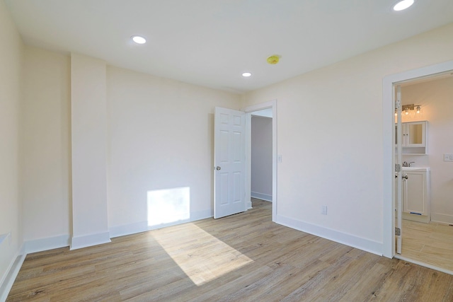 spare room with light hardwood / wood-style flooring and sink