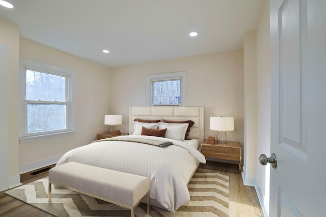 bedroom featuring light hardwood / wood-style flooring and multiple windows