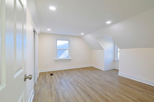 bonus room featuring light hardwood / wood-style flooring and vaulted ceiling