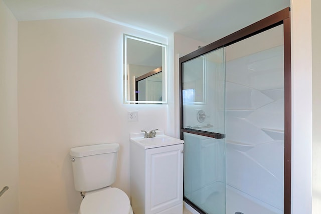 bathroom with vanity, toilet, and a shower with door