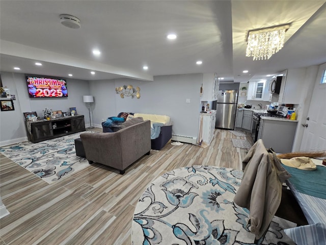 living room with light wood-type flooring and baseboard heating