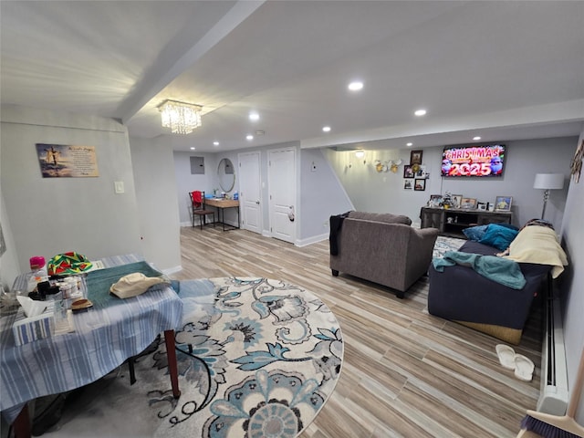 living room with an inviting chandelier and light wood-type flooring